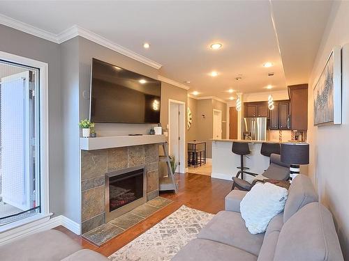 213-1325 Bear Mountain Pkwy, Langford, BC - Indoor Photo Showing Living Room With Fireplace