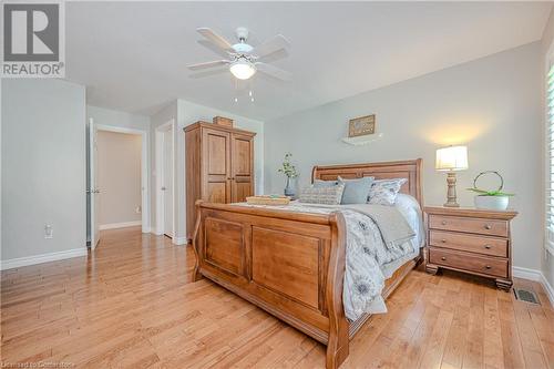 Primary suite with hardwood floors and walk in closet - 310 Lanark Street, Caledonia, ON - Indoor Photo Showing Bedroom