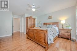 Primary suite with hardwood floors and walk in closet - 