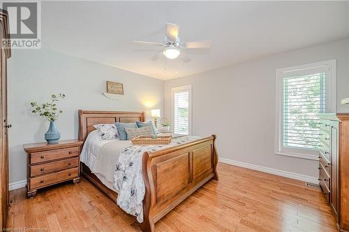 Primary suite with hardwood floors and walk in closet - 310 Lanark Street, Caledonia, ON - Indoor Photo Showing Bedroom