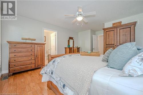 Primary suite with hardwood floors and walk in closet - 310 Lanark Street, Caledonia, ON - Indoor Photo Showing Bedroom