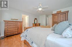 Primary suite with hardwood floors and walk in closet - 