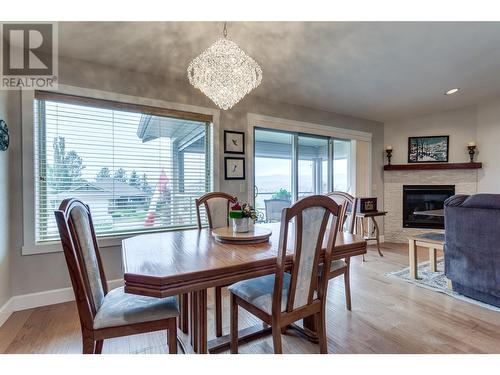 3474 Pine Valley Drive, Kelowna, BC - Indoor Photo Showing Dining Room With Fireplace