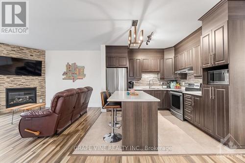 2 - 181 Bourdeau Boulevard, Prescott And Russell, ON - Indoor Photo Showing Kitchen With Fireplace With Upgraded Kitchen