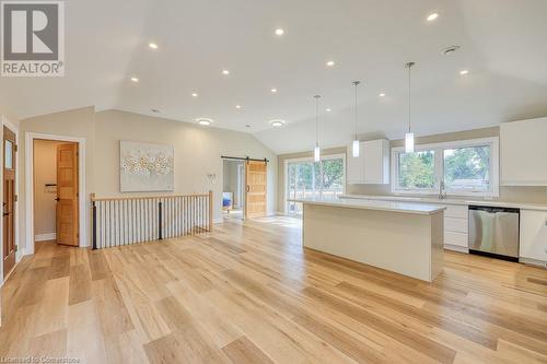 View showing 2 piece bath, stairs to basement, sliding doors to deck and yard. - 6765 James Street, London, ON - Indoor Photo Showing Kitchen With Upgraded Kitchen