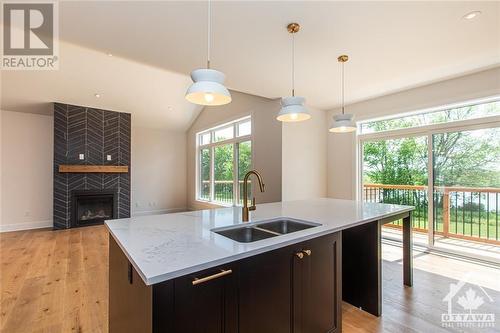 *Selections will differ - Lot 9 Flanders Road, Brockville, ON - Indoor Photo Showing Kitchen With Fireplace With Double Sink