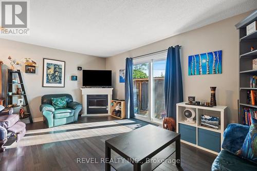 12 - 65 Dorchester Boulevard, St. Catharines, ON - Indoor Photo Showing Living Room With Fireplace