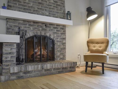 Living room - 135 Place Bonnard, Québec (Beauport), QC - Indoor With Fireplace