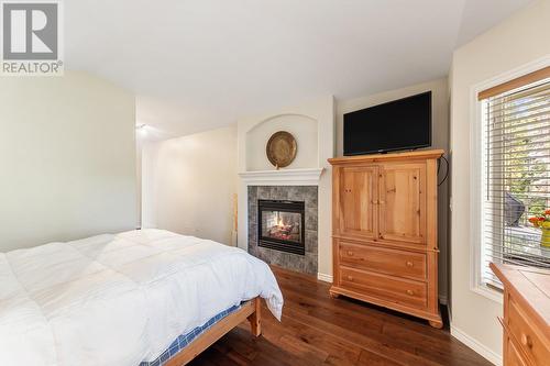 4117 Gallaghers Boulevard S, Kelowna, BC - Indoor Photo Showing Bedroom With Fireplace