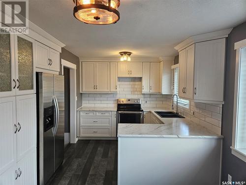 14 Macrae Bay, Carlyle, SK - Indoor Photo Showing Kitchen With Double Sink