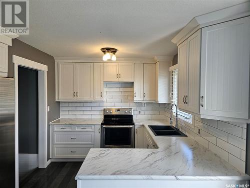 14 Macrae Bay, Carlyle, SK - Indoor Photo Showing Kitchen With Double Sink