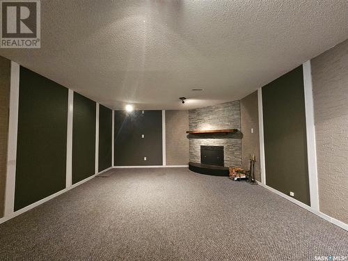 14 Macrae Bay, Carlyle, SK - Indoor With Fireplace