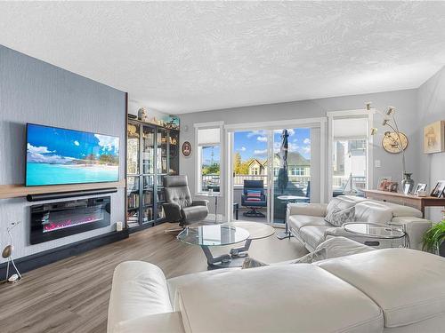 304-9717 Third St, Sidney, BC - Indoor Photo Showing Living Room With Fireplace