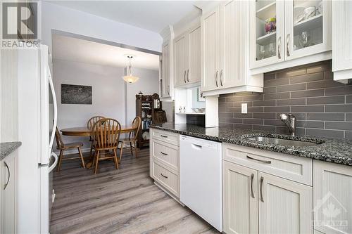 Step into a kitchen designed to impress with its sophisticated blend of style and functionality. Featuring stunning granite countertops, this kitchen offers ample space for meal preparation and ca - 4629 Carrington Place, Ottawa, ON - Indoor Photo Showing Kitchen With Upgraded Kitchen