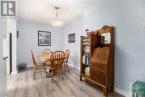 Clean cohesive lines accent this large dining area with natural light from kitchen and dining chandelier. - 4629 Carrington Place, Ottawa, ON - Indoor Photo Showing Dining Room