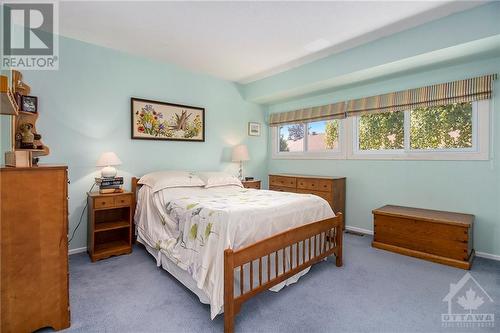 Experience the privacy of this principal bedroom, beautifully basked in natural light. Large windows invite an abundance of sunshine, creating a bright and airy atmosphere that enhances the room’s - 4629 Carrington Place, Ottawa, ON - Indoor Photo Showing Bedroom