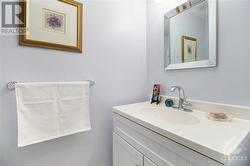 Thoughtfully designed, this powder room features a sleek, one-piece countertop that combines both style and ease of maintenance. - 