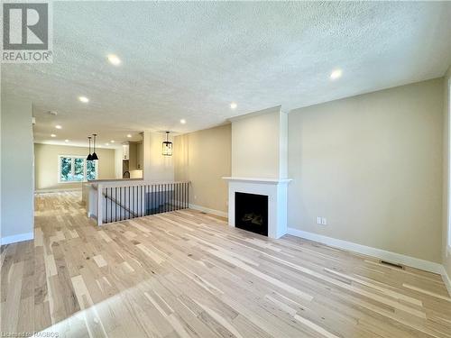 Living room with hardwood floors and gas fireplace - 15 Nyah Court, Tiverton, ON - Indoor With Fireplace