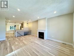 Living room with hardwood floors and gas fireplace - 