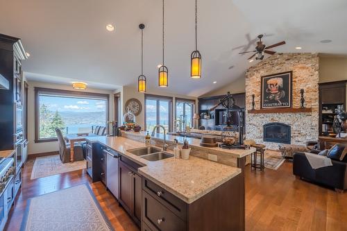 136 Flagstone Rise, Naramata, BC - Indoor Photo Showing Kitchen With Fireplace With Double Sink