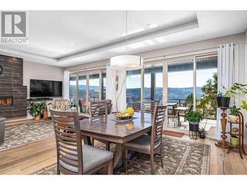 8972 Bayswater Place, Vernon, BC - Indoor Photo Showing Dining Room With Fireplace