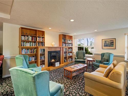 115-1485 Garnet Rd, Saanich, BC - Indoor Photo Showing Living Room With Fireplace