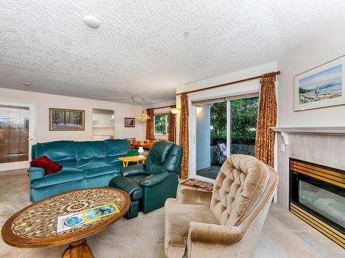 102-9993 Fourth St, Sidney, BC - Indoor Photo Showing Living Room With Fireplace