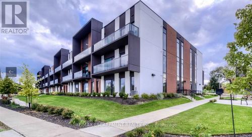 210 - 5 Wake Robin Drive, Kitchener, ON - Outdoor With Balcony With Facade