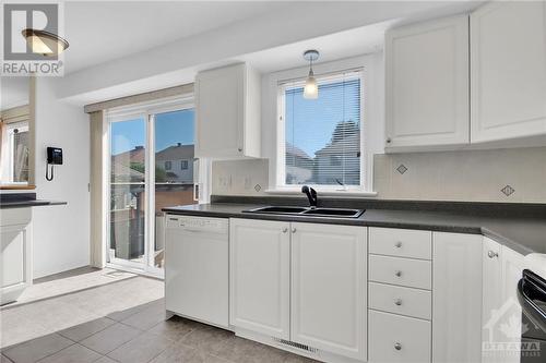 Bright windows and access to the back deck - 14 Knowlton Drive, Ottawa, ON - Indoor Photo Showing Kitchen With Double Sink