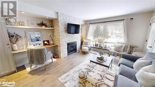 1235 Deerhurst Drive Unit# 52-308, Huntsville, ON - Indoor Photo Showing Living Room With Fireplace