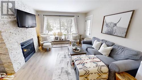 1235 Deerhurst Drive Unit# 52-308, Huntsville, ON - Indoor Photo Showing Living Room With Fireplace