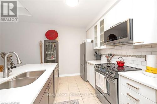 101 - 5070 Fairview Street, Burlington, ON - Indoor Photo Showing Kitchen With Double Sink