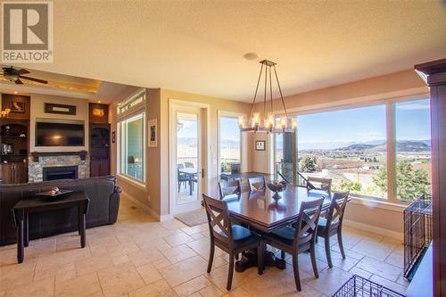 5071 Lipkovits Road, Kelowna, BC - Indoor Photo Showing Dining Room With Fireplace