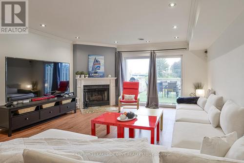 Overlooking the Water -North West EXPOSURE - 23 - 100 Laguna Parkway N, Ramara, ON - Indoor Photo Showing Living Room With Fireplace