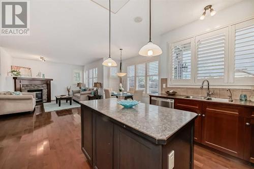 11 Crestridge Way Sw, Calgary, AB - Indoor Photo Showing Kitchen With Fireplace With Double Sink