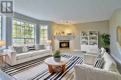 Virtually Staged - 212 Scenic Acres Terrace Nw, Calgary, AB - Indoor Photo Showing Living Room With Fireplace