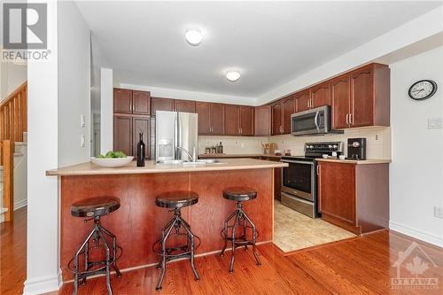 Efficiently designed kitchen; this photo has been digitally staged - 507 Cherokee Way, Stittsville, ON - Indoor Photo Showing Kitchen