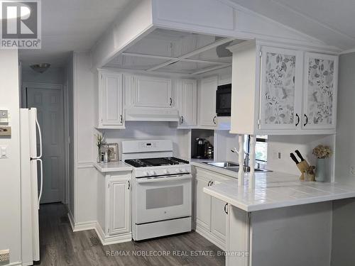 224 - 85 Theme Park Drive N, Wasaga Beach, ON - Indoor Photo Showing Kitchen With Double Sink