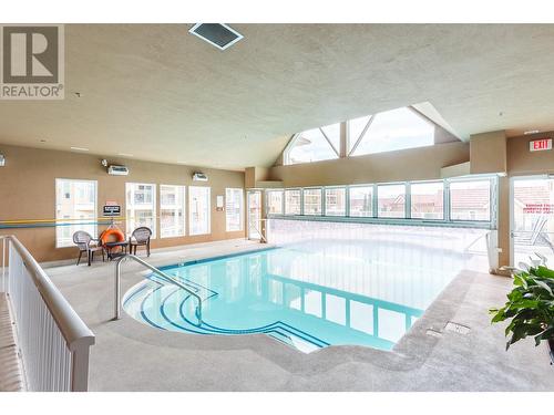 1088 Sunset Drive Unit# 633, Kelowna, BC - Indoor Photo Showing Other Room With In Ground Pool