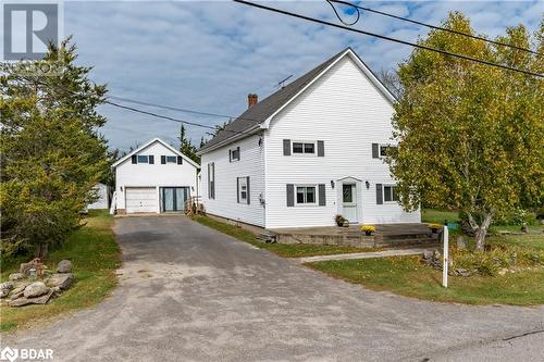 View of front facade featuring an outdoor structure and a garage - 1868 County Road 14, Ameliasburg, ON - Outdoor