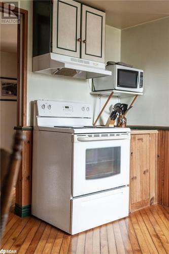 Kitchen featuring light hardwood / wood-style flooring and white appliances - 1868 County Road 14, Ameliasburg, ON - Indoor Photo Showing Kitchen