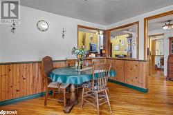 Dining space with wooden walls and light hardwood / wood-style flooring - 