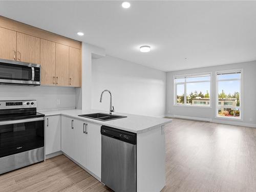 303-6544 Metral Dr, Nanaimo, BC - Indoor Photo Showing Kitchen With Double Sink