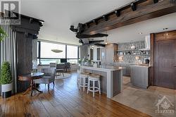 Beautiful rich toned wide plank floor boards highlight the kitchen and dining area - 