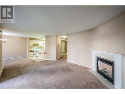 250 Scott Avenue Unit# 104, Penticton, BC - Indoor Photo Showing Living Room With Fireplace