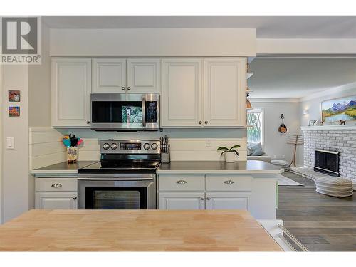 4531 Raymer Road, Kelowna, BC - Indoor Photo Showing Kitchen With Fireplace