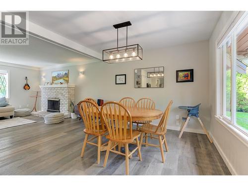 4531 Raymer Road, Kelowna, BC - Indoor Photo Showing Dining Room With Fireplace