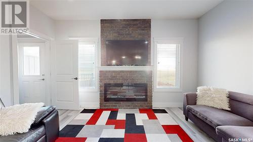 3118 Mazurak Crescent, Regina, SK - Indoor Photo Showing Living Room With Fireplace