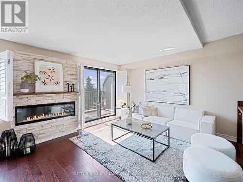 409 - 1000 Cedarglen Gate, Mississauga, ON - Indoor Photo Showing Living Room With Fireplace