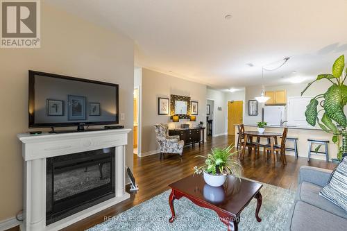 212 - 383 Main Street E, Milton, ON - Indoor Photo Showing Living Room With Fireplace